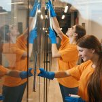 cleaning crew cleaning glass office door