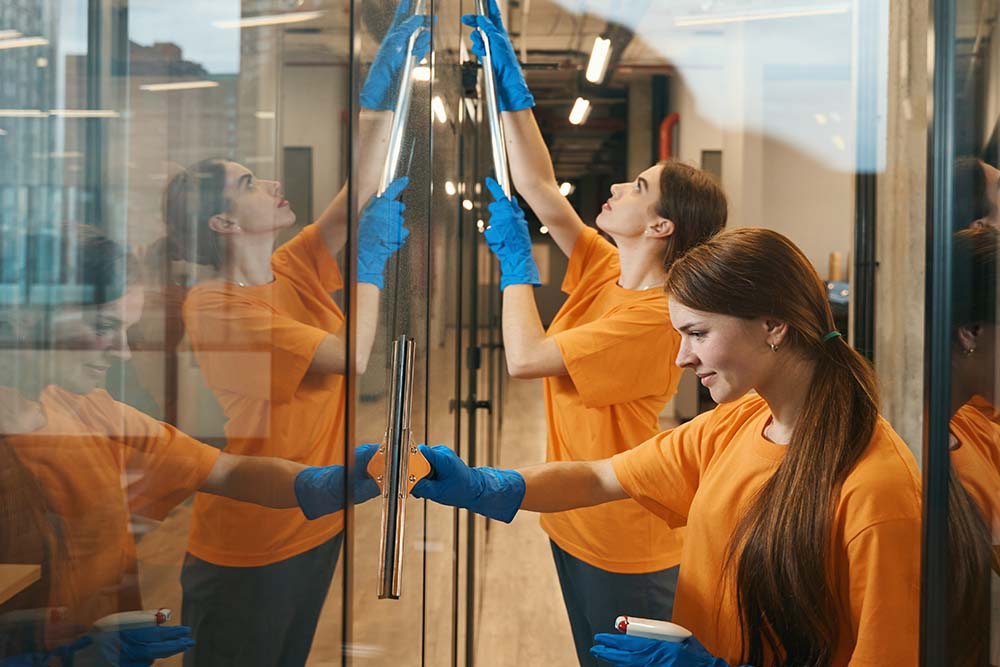 cleaning crew cleaning glass office door