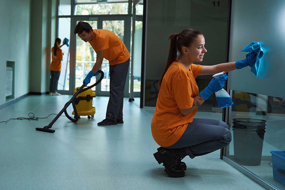 Professional commercial cleaning crew cleaning an office building.